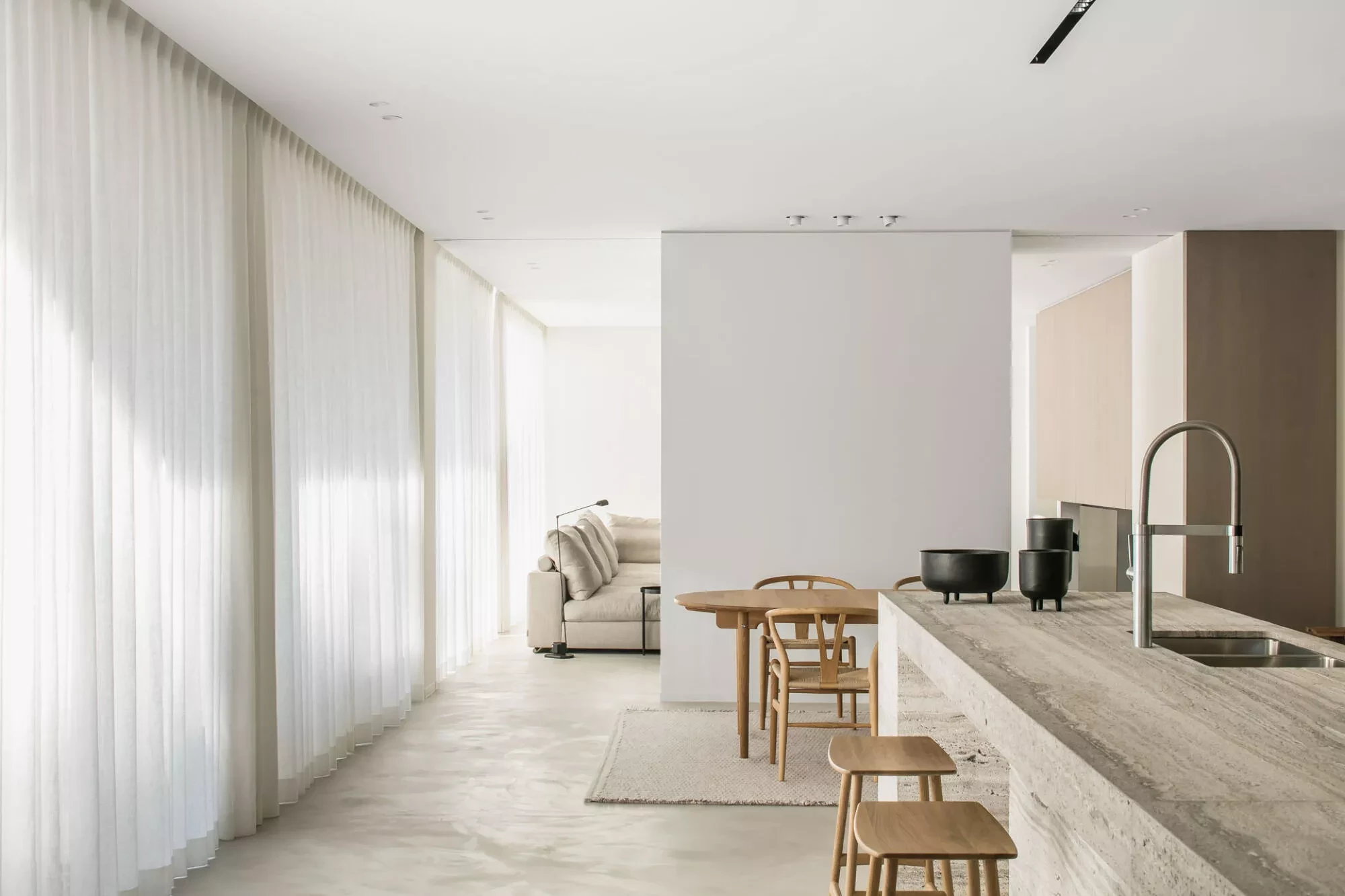 Thalostuc floor finish extending between kitchen and living room inside interior by Pieter Vanrenterghem