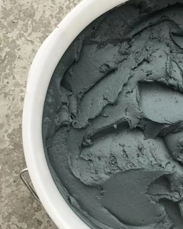 Bucket of freshly mixed, pigmented Odilon material, ready to become a sample