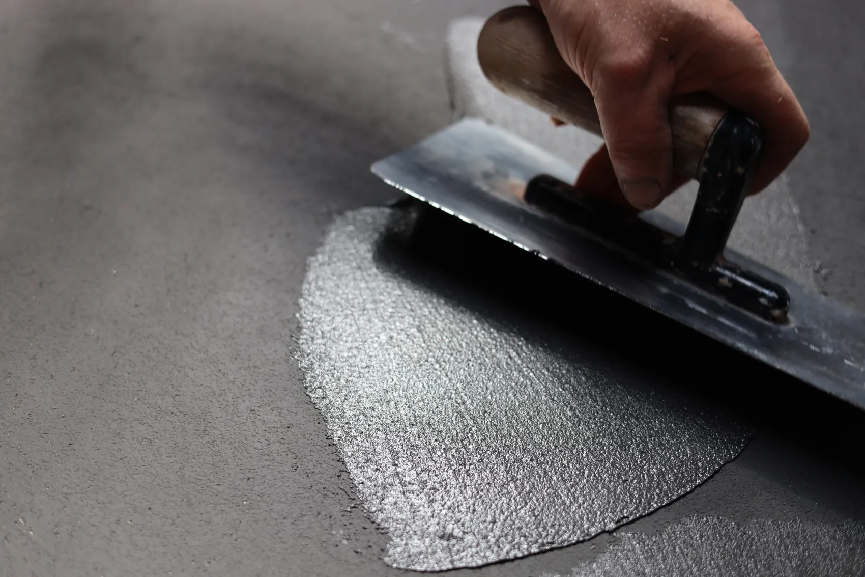 A trowel applying an Odilon surface finish by hand