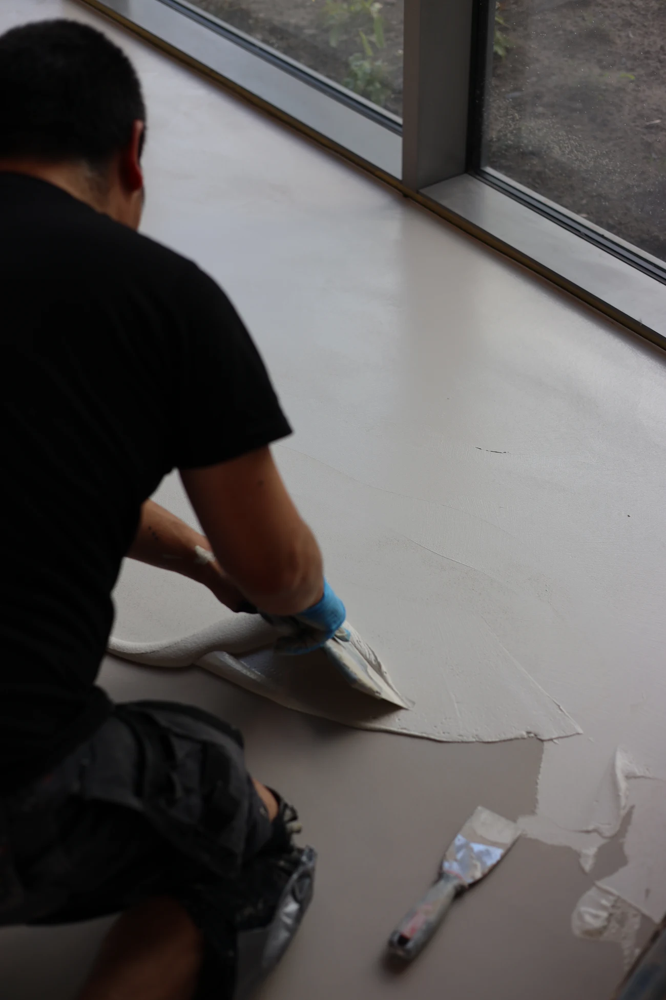 Craftsman hand-troweling an Odilon mineral floor finish